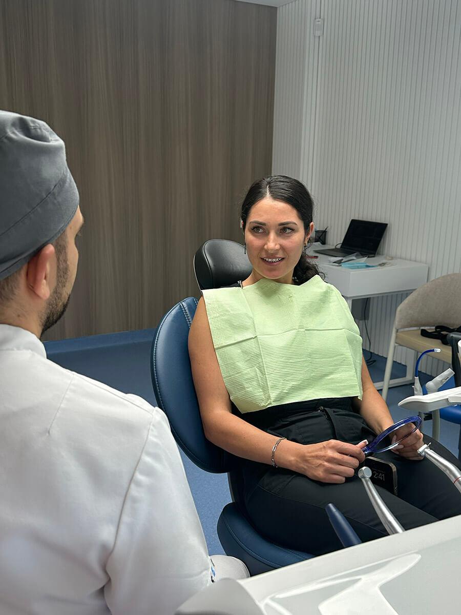 Dentist consulting a patient in the treatment room